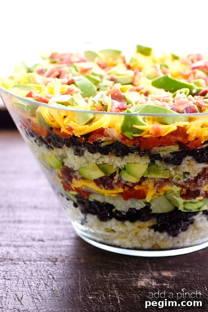Mimi's Mexican Cornbread Salad Recipe: Zesty Corn & Tomato 2 Mexican Cornbread Salad makes a delicious layered salad recipe using buttermilk cornbread, beans, tomatoes, and so much more! // addapinch.com