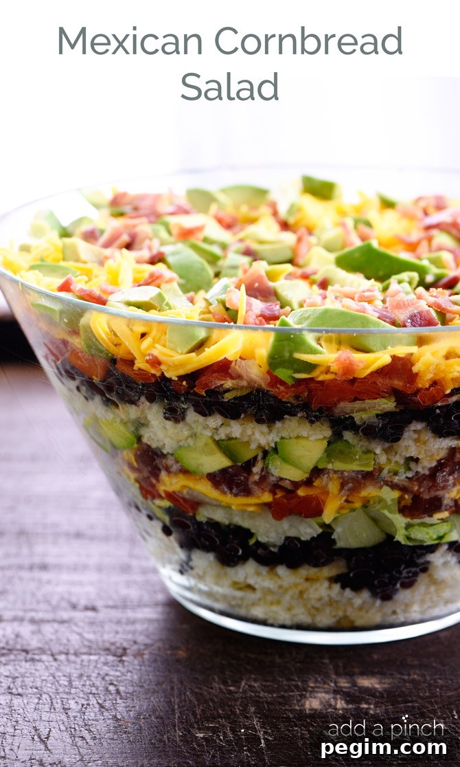 Mimi's Mexican Cornbread Salad Recipe: Zesty Corn & Tomato 3 Mexican Cornbread Salad makes a delicious layered salad recipe using cornbread, beans, tomatoes, and so much more! // addapinch.com